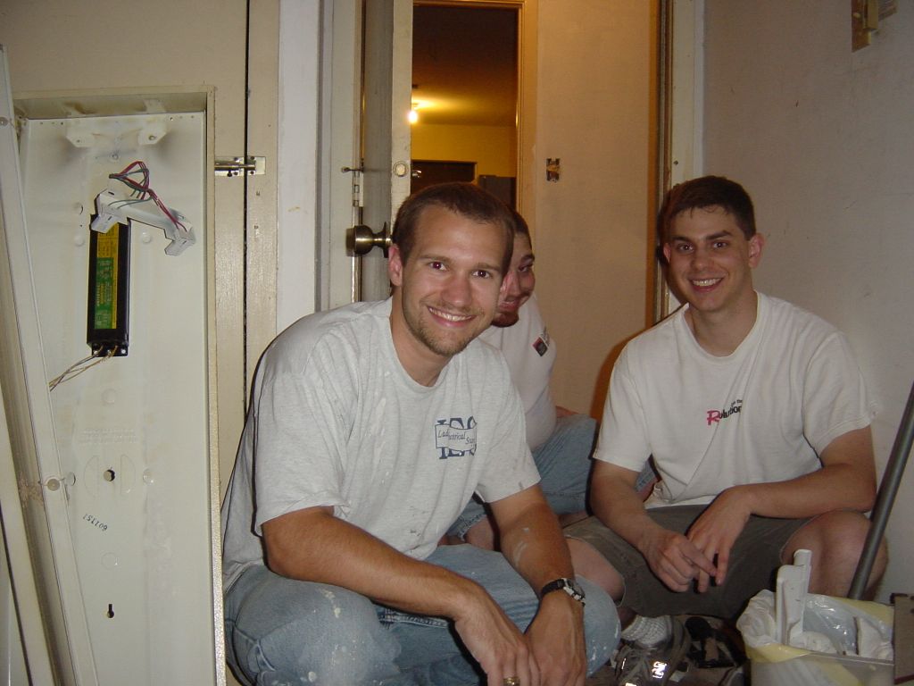 
Rick and Matt, after tiling in the laundry room.  Erich tries to hide behind
Rick, but fails.
