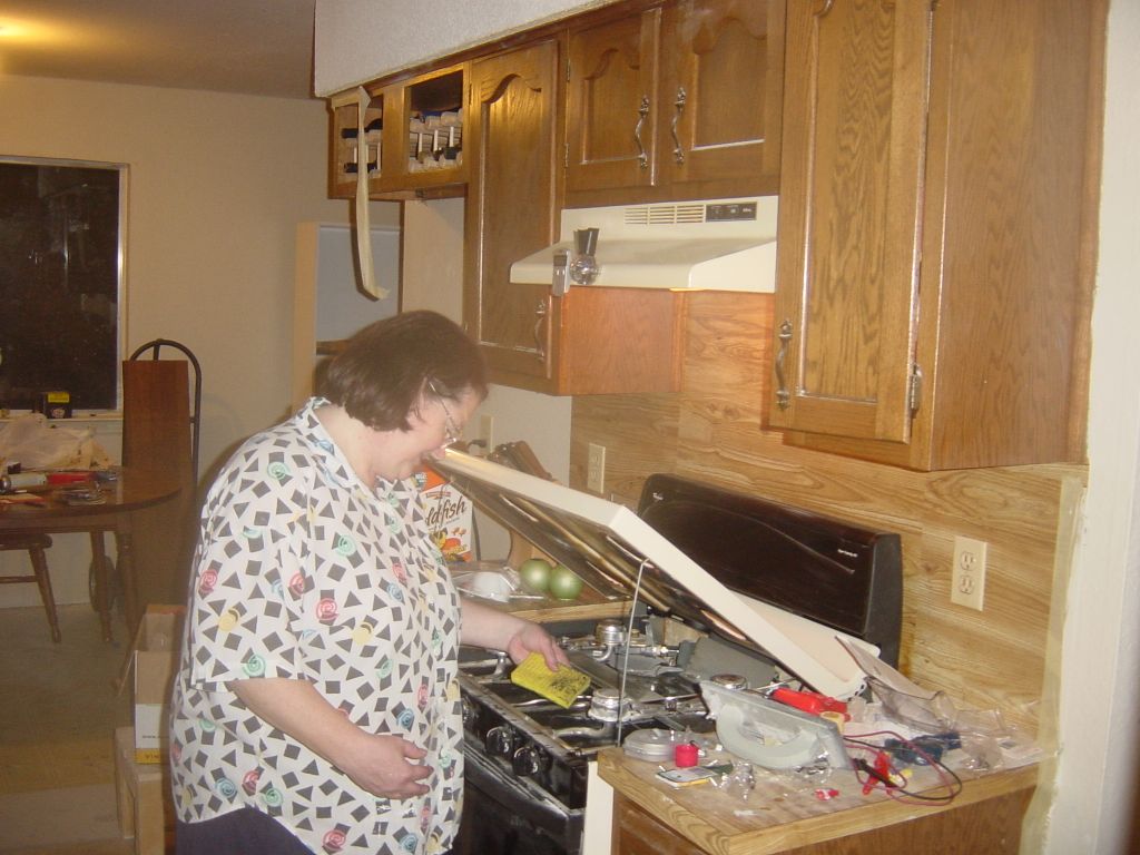
Mom cleaning my stove and unpacking the kitchen
