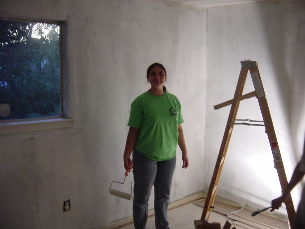 
Gwyneth smiling at her work priming the back bedroom
