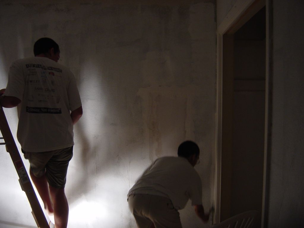 
Chris is trying to use his feet to make shadow puppets.  Tang isn't impressed,
goes back to priming the corners.

