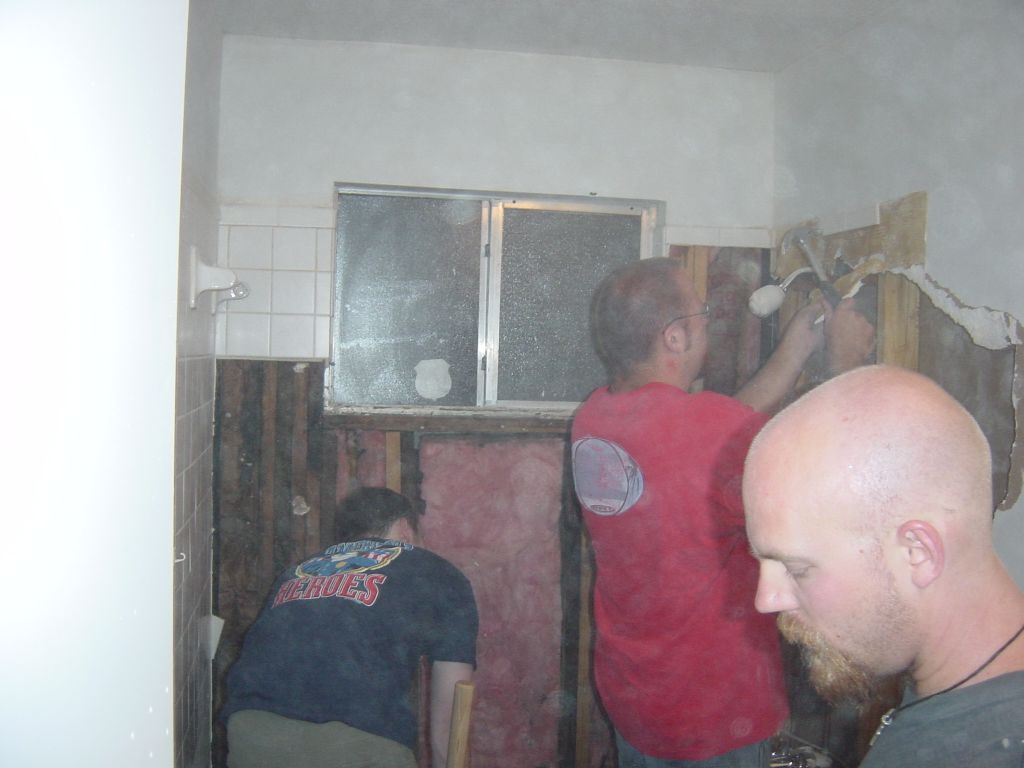 
Eric works on the bits around the shower output, David inspects the wood rot
under the window
