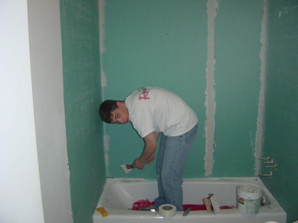 
Matt applies joint compound after the other two drywall pieces go up.
