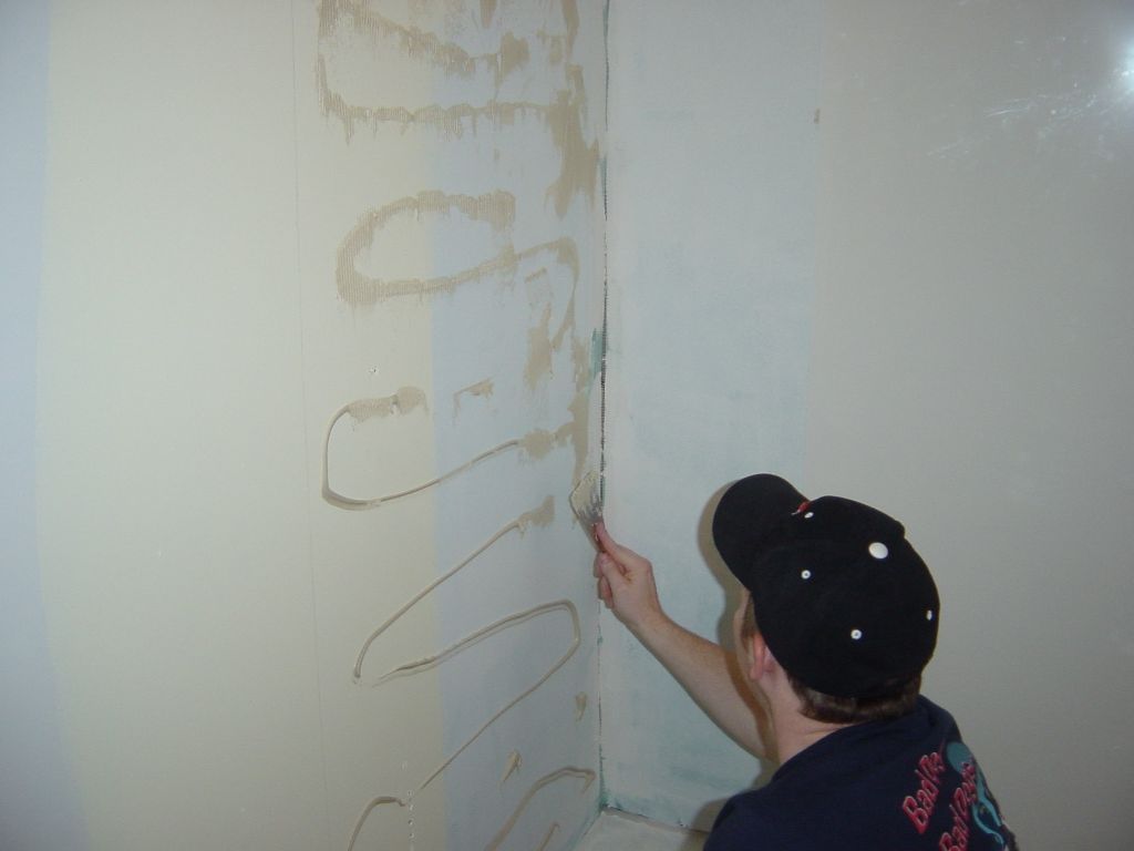 
David trowels the liquid nails shower surround compound.
