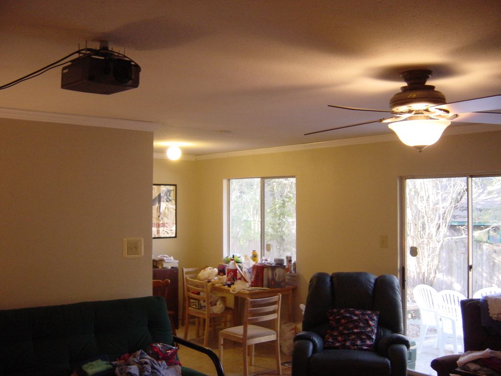 

The back family room / breakfast room.  New ceiling fan, mounted projector.
The projector cables will eventually be run through attic and though 
the pipe holding the projector up.  Thanks to Evanda and PeterD for the
projector mount.
